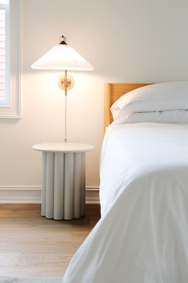 The spacious primary bedroom is a serene place to relax and recharge. The primary features a king sized bed, accents from CB2, walk-in closet, 50" Smart TV, and a full bath with a soaking tub and standup shower. 