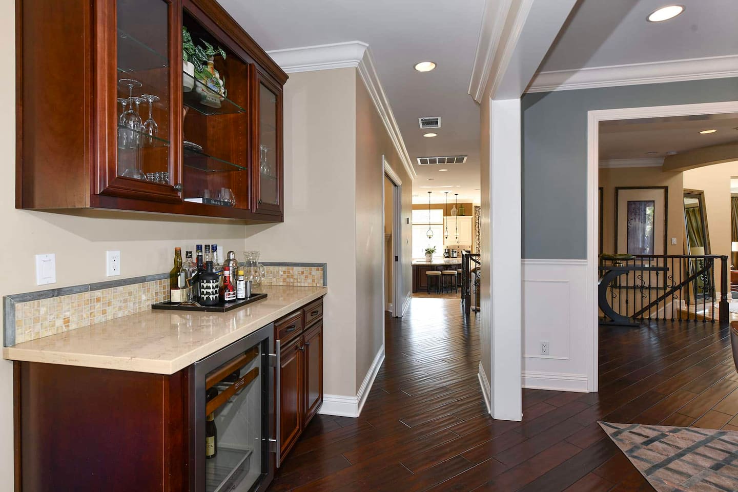 Bar in the entrance with a wine fridge.