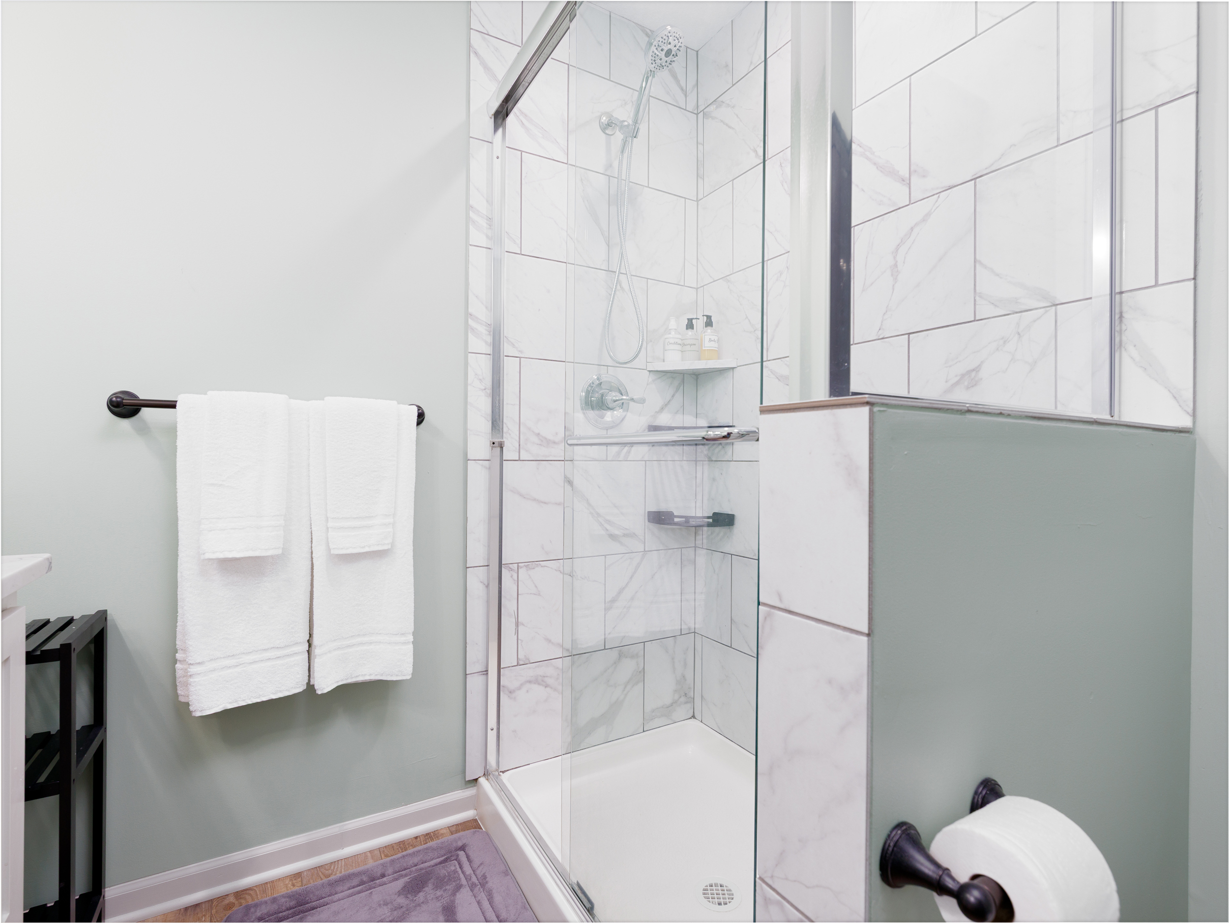 Private ensuite bathroom featuring a walk-in shower and clean, contemporary finishes.