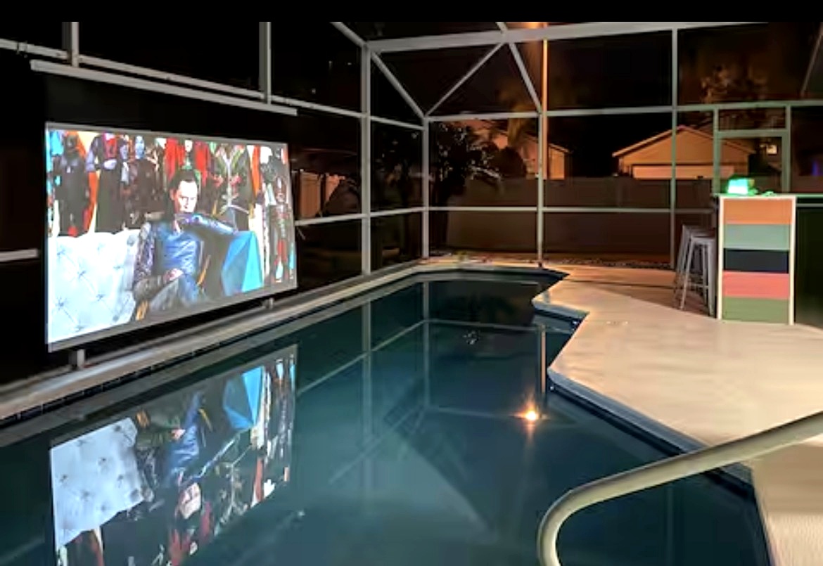 Float under the stars in your own private poolside movie theater — warm water, glowing lights, and pure nighttime magic.