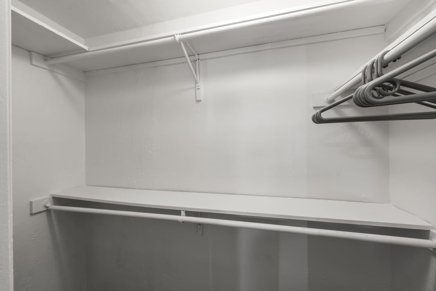 Spacious closet with hangers and built-in shelving—perfect for unpacking and staying organized during your stay.