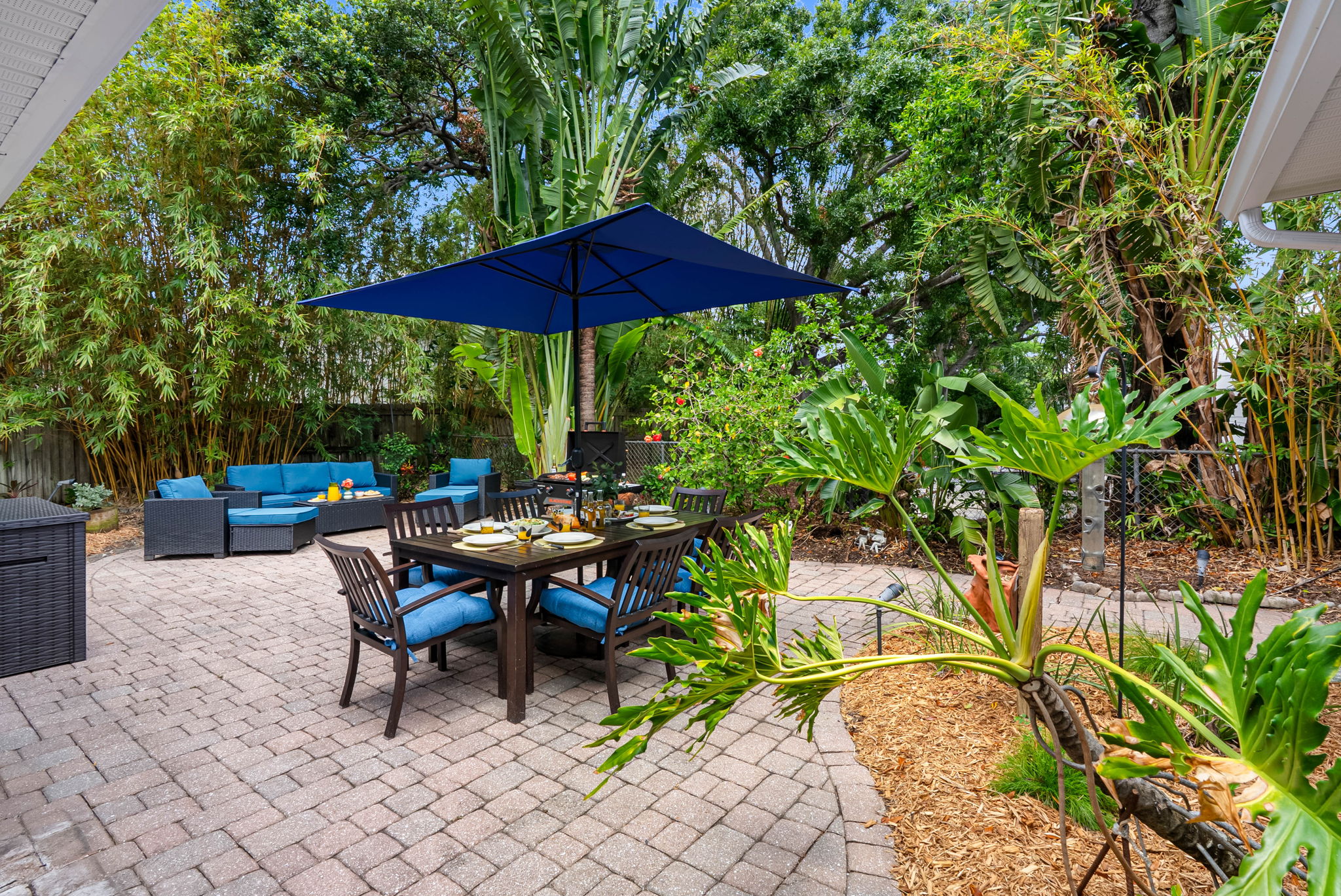 As the sun sets, the soft outdoor lighting and lantern-style fixture create a cozy glow, making this space just as inviting at night as it is during the day.