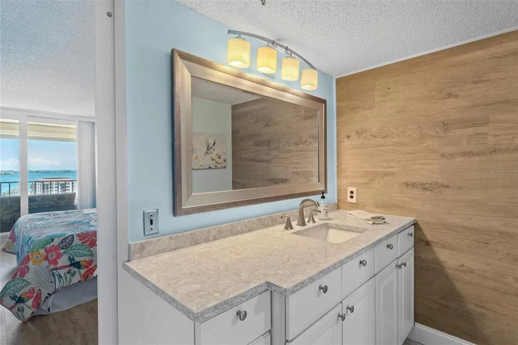 The en-suite master bathroom features a spacious, clean layout with modern finishes, fresh towels, and thoughtful details designed for comfort and convenience.
