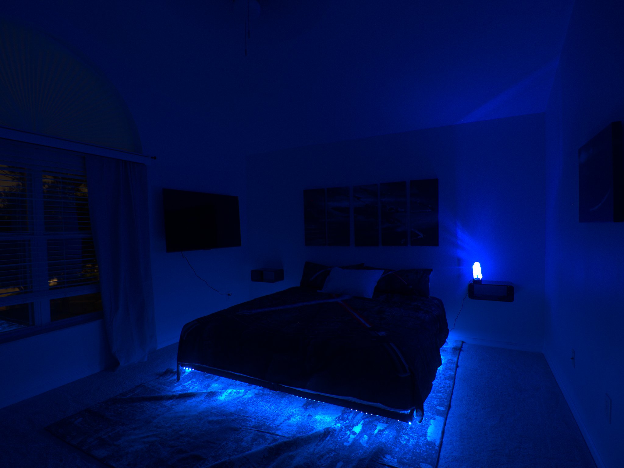 Star Wars room with king bed, LED lights, and R2D2 projection. 