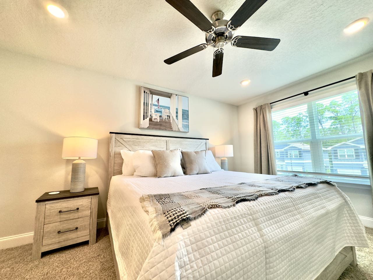 After a long day, this bed pulls you in — soft pillows, weighted comfort, carpet cushioning tired feet. Fan humming gently; eyes grow heavy, ready to rest.