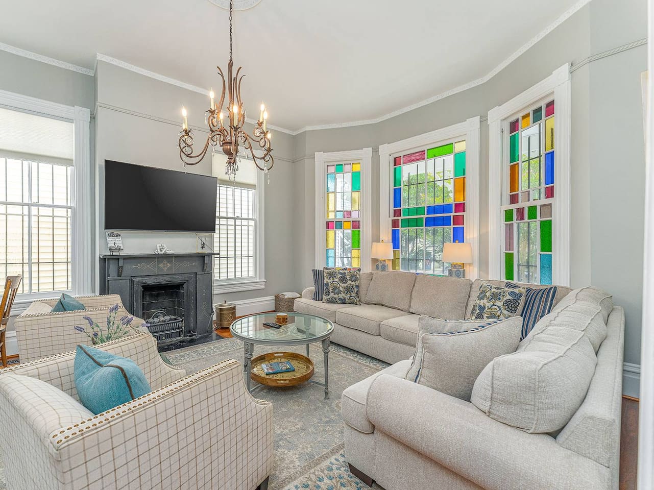 Stain glass windows facing south let in brilliant light throughout the day!  Spacious with double pocket doors leading into the dining room - great for entertaining.  Close the pocket doors, pull out the sofa bed make this living room a 4th bedroom!