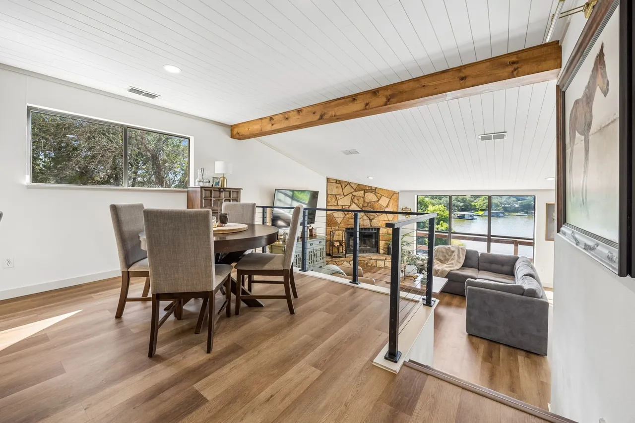 Cozy lake-view seating beside the stone fireplace.