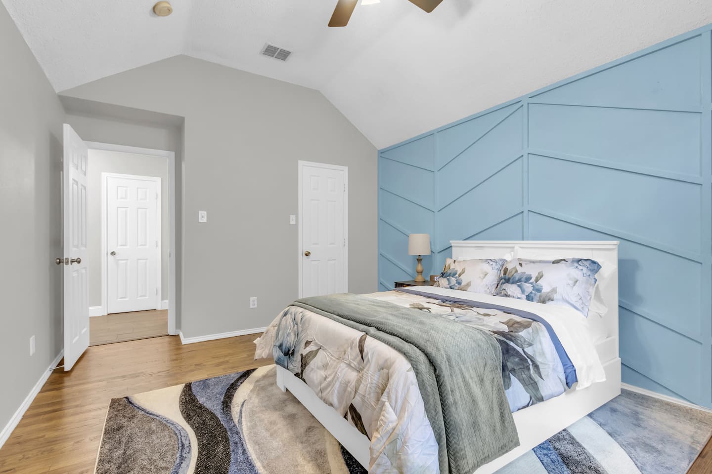 Clean and spacious guest bedroom offering a queen bed, room-darkening blinds, ceiling fan, fresh linens, and climate comfort for a great night’s sleep.