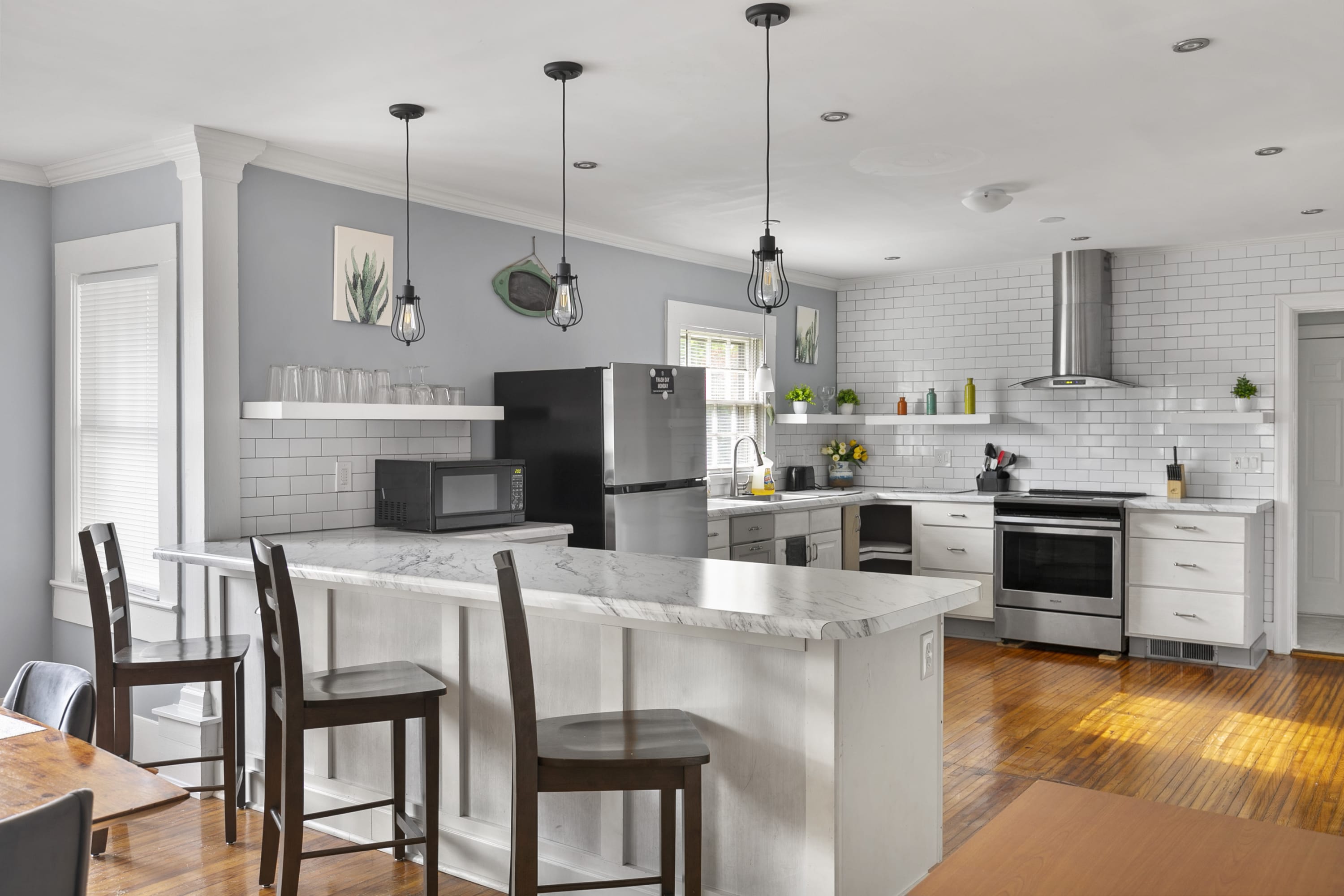 A bright kitchen with sleek finishes and three bar seats—perfect for casual meals or morning coffee