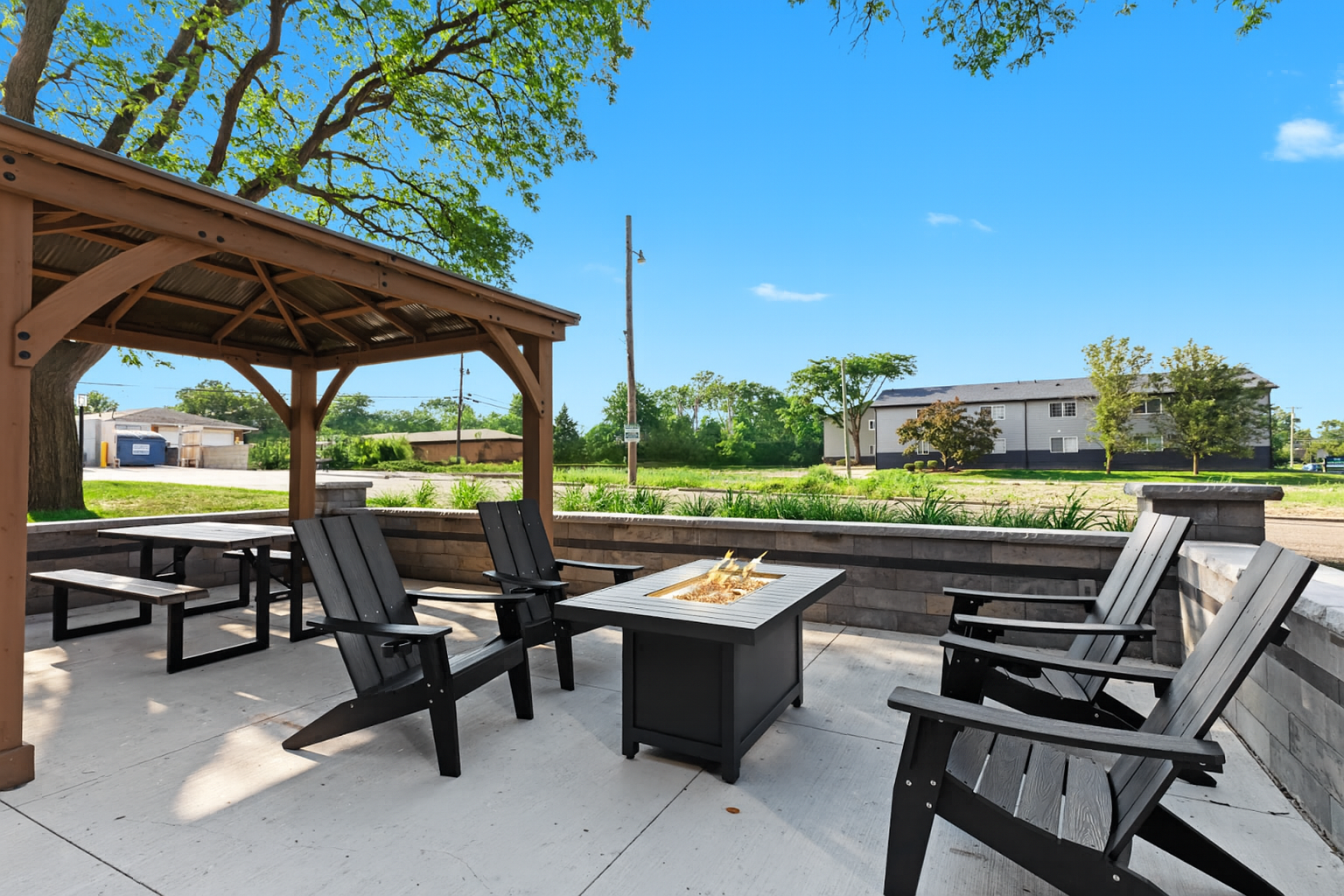 Spacious outdoor seating area with grill and picnic tables—perfect for relaxing with friends or family.