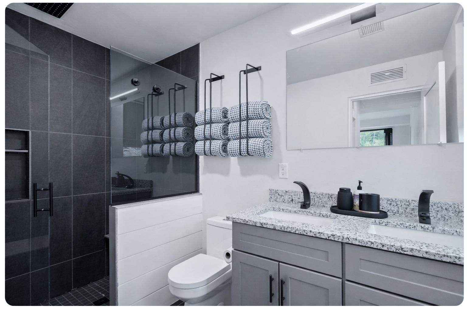 Primary en suite bathroom provides a luxurious spa like shower experience.