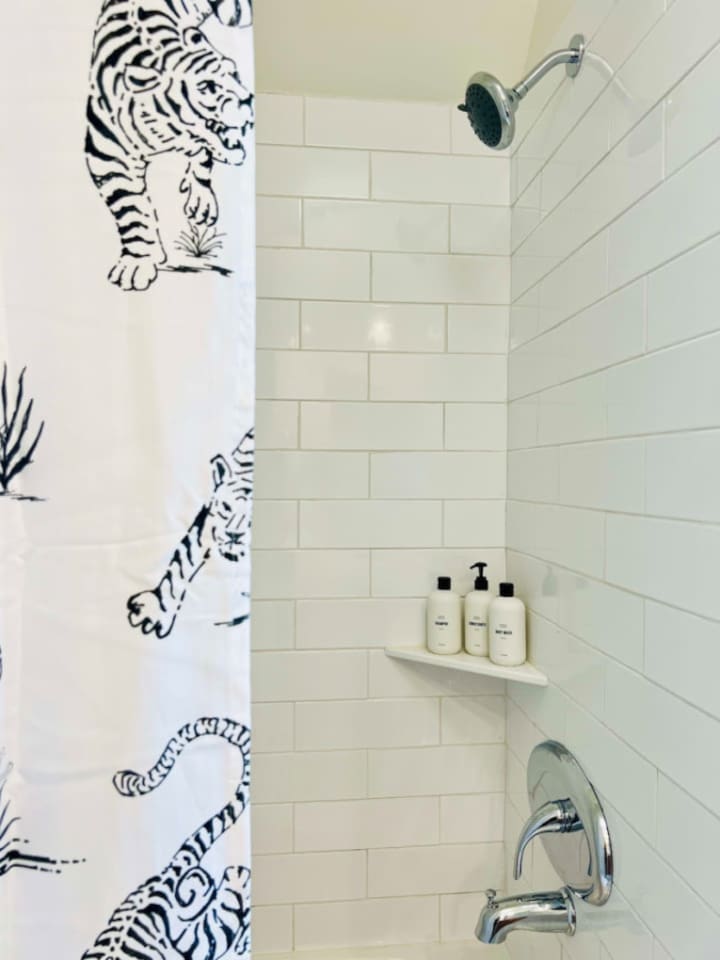 Modern full bathroom, featuring sleek fixtures and all the amenities you need for a comfortable and refreshing experience.