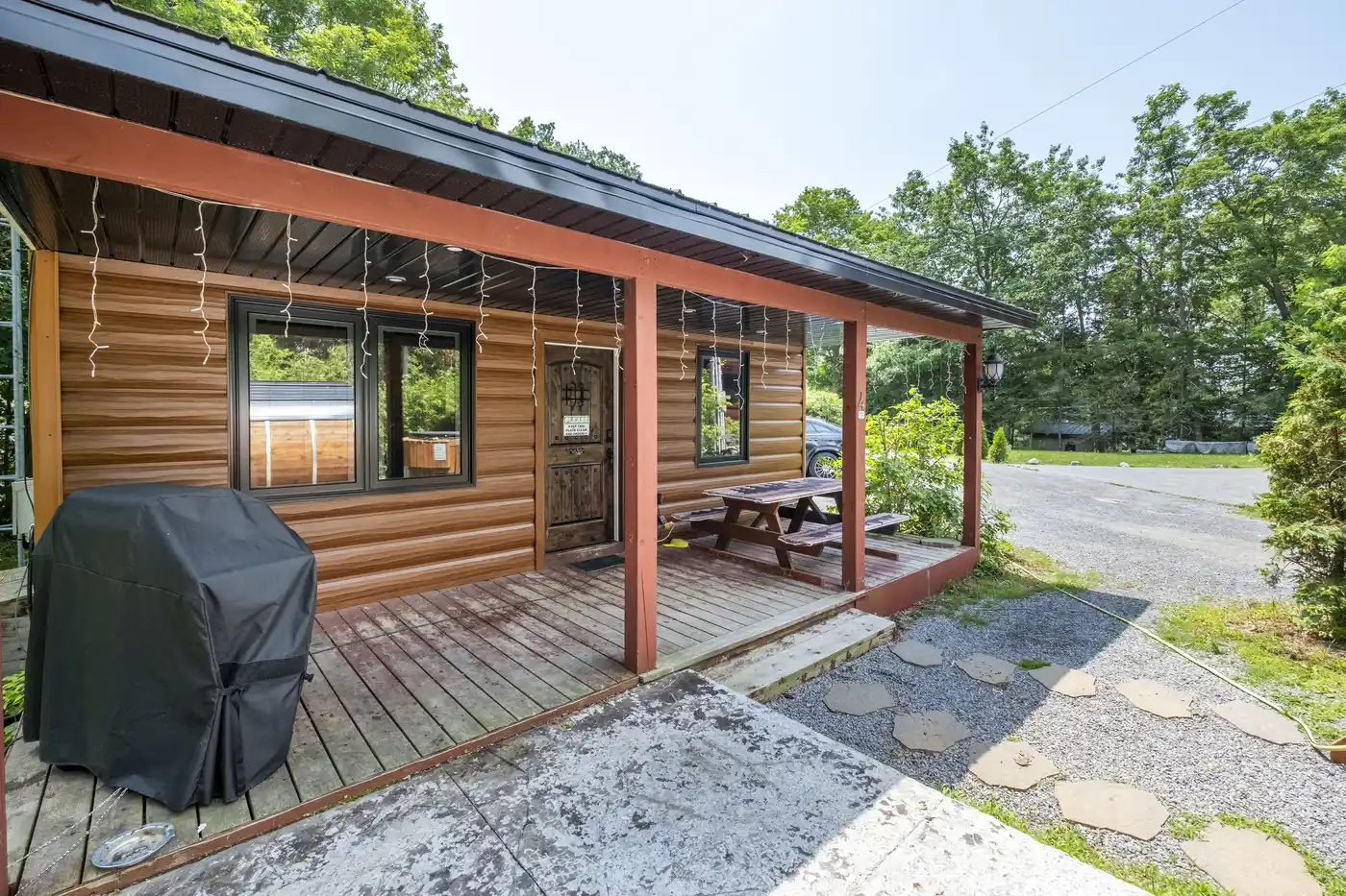 Cottage #4 exterior with covered porch and outdoor grill