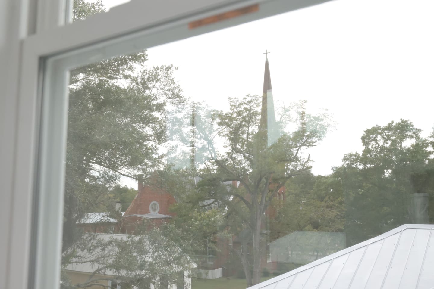 The lookout is surrounded by windows for views of the historic downtown neighborhood. Look for the church steeples.