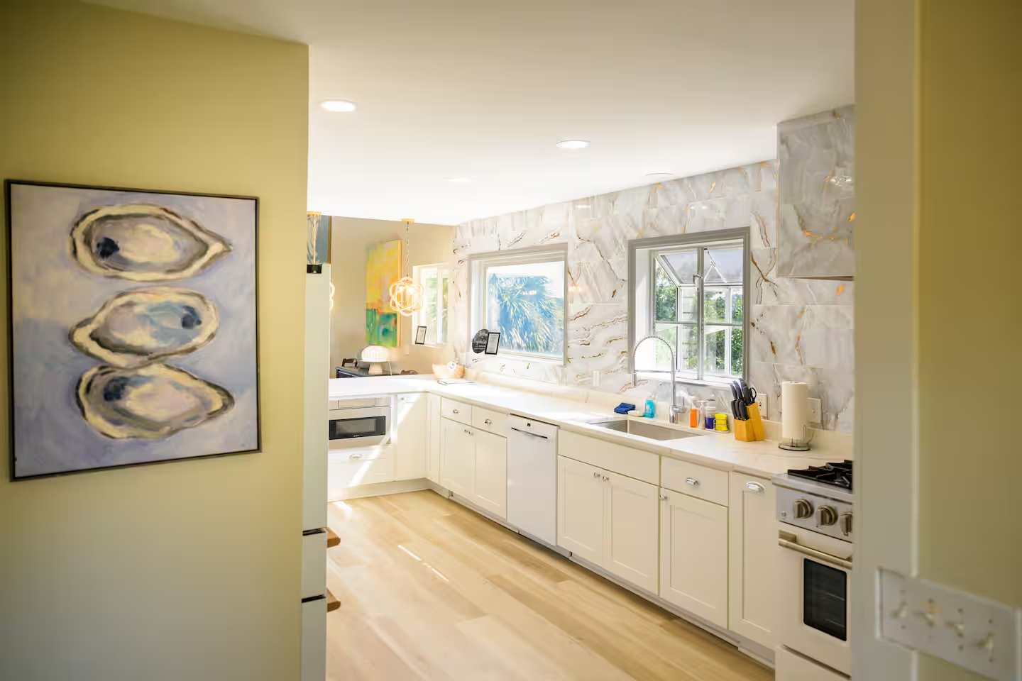 Framed by local artwork and flooded with light, this kitchen is where comfort meets creativity.