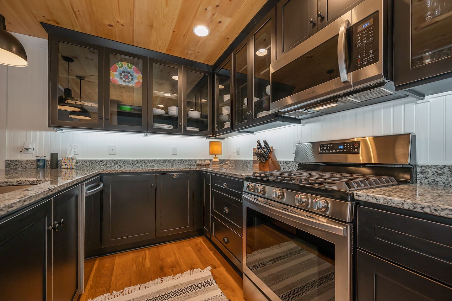 Upgraded kitchen area with stainless steal appliances and seating area