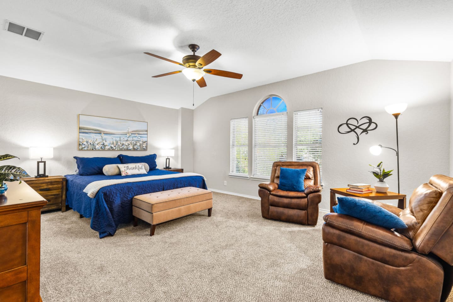 Relaxing primary retreat with a king bed, dedicated reading nook, room-darkening shades, plush linens, and a Smart TV with full streaming options.
