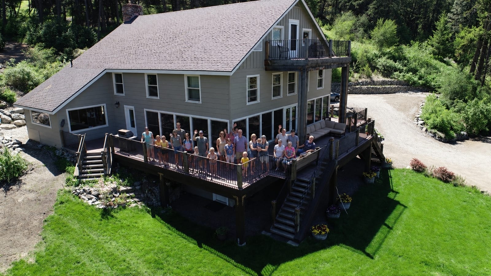 Large family gathered on the deck at The Lodge at Palmer Lake