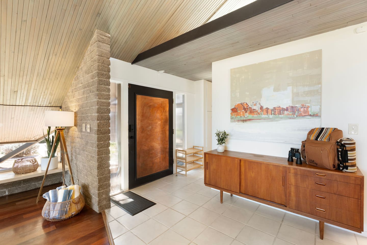 Stylish entryway with warm wood accents and a welcoming mid-century touch.