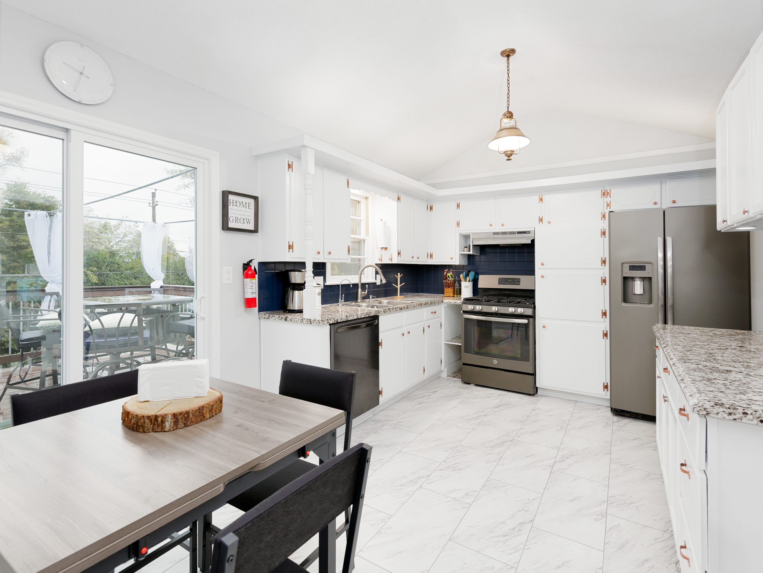 Spacious, light-filled kitchen featuring full-size appliances and generous counter space for everyday cooking.