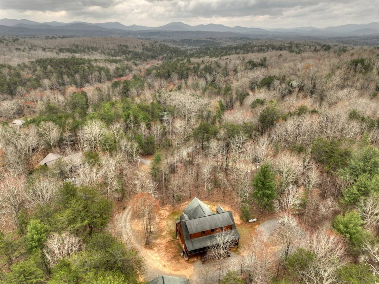 Capture a bird's-eye view of the house from above using a drone