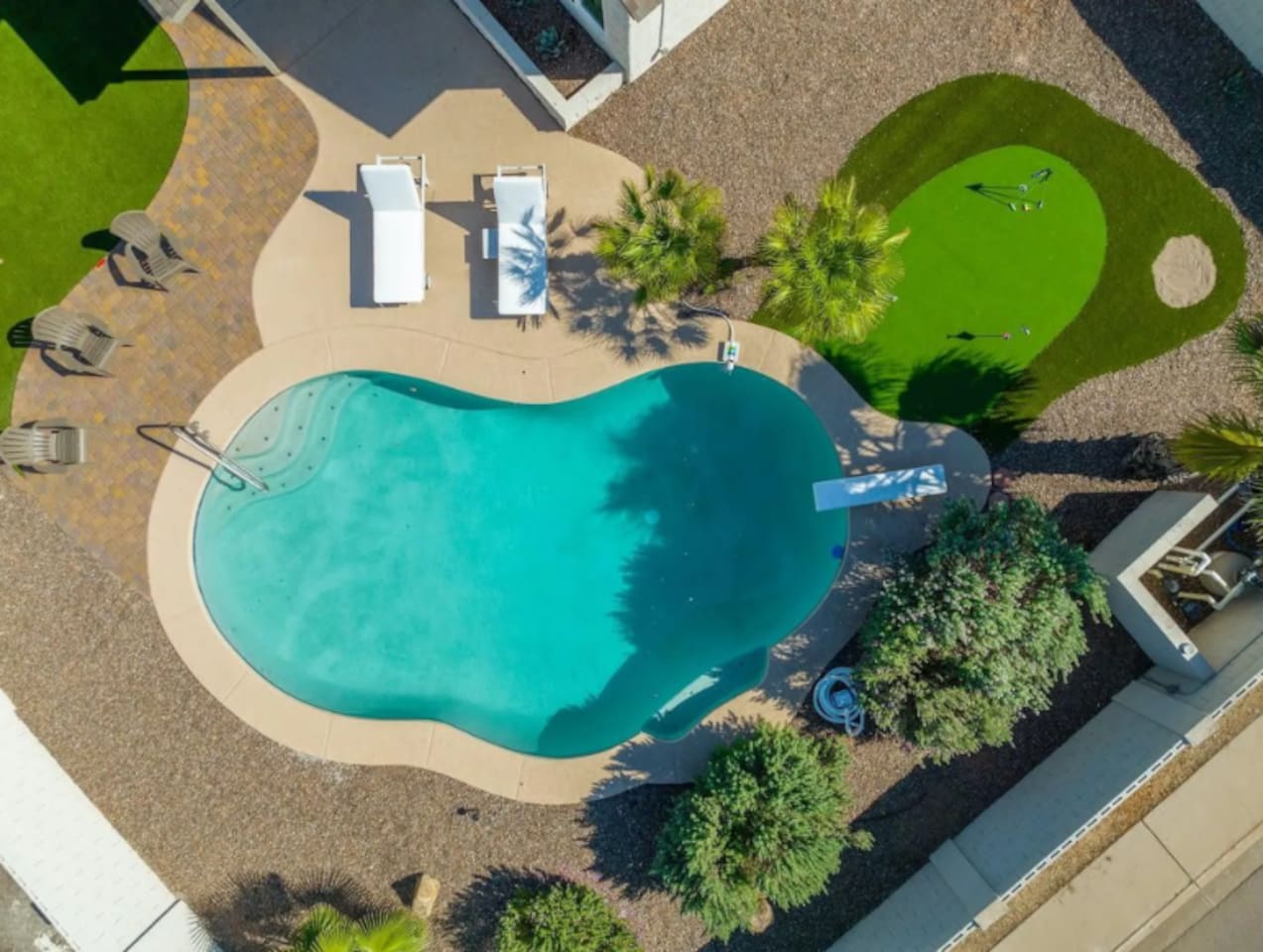Sparkling lagoon-style pool with lounging areas, putting green, and resort-quality amenities.