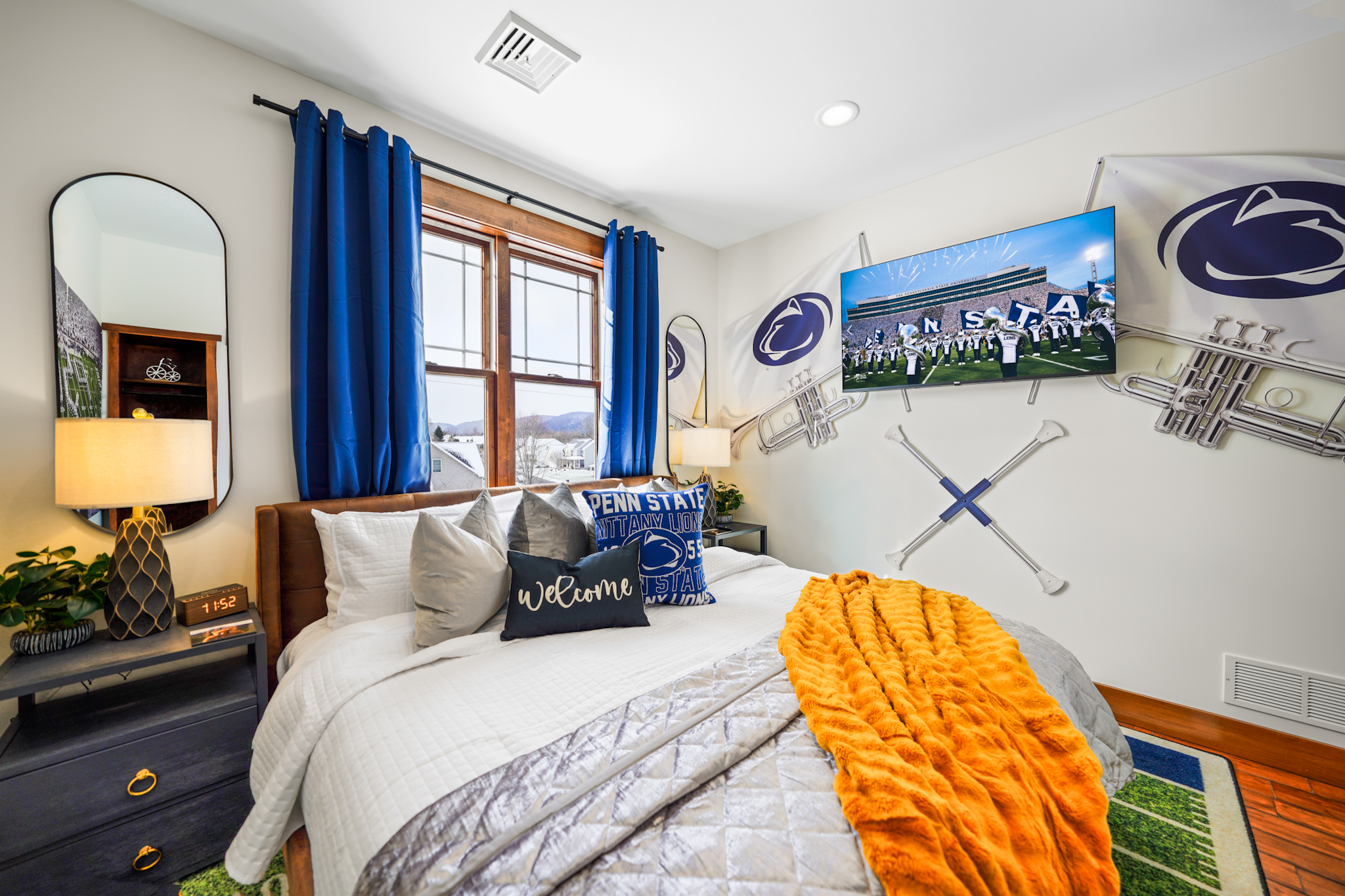 King bedroom inspired by Penn State tradition, featuring an ensuite bath and comfortable sleeping space.