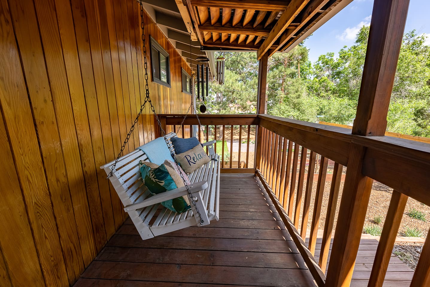 Covered porch swing overlooking the side yard 