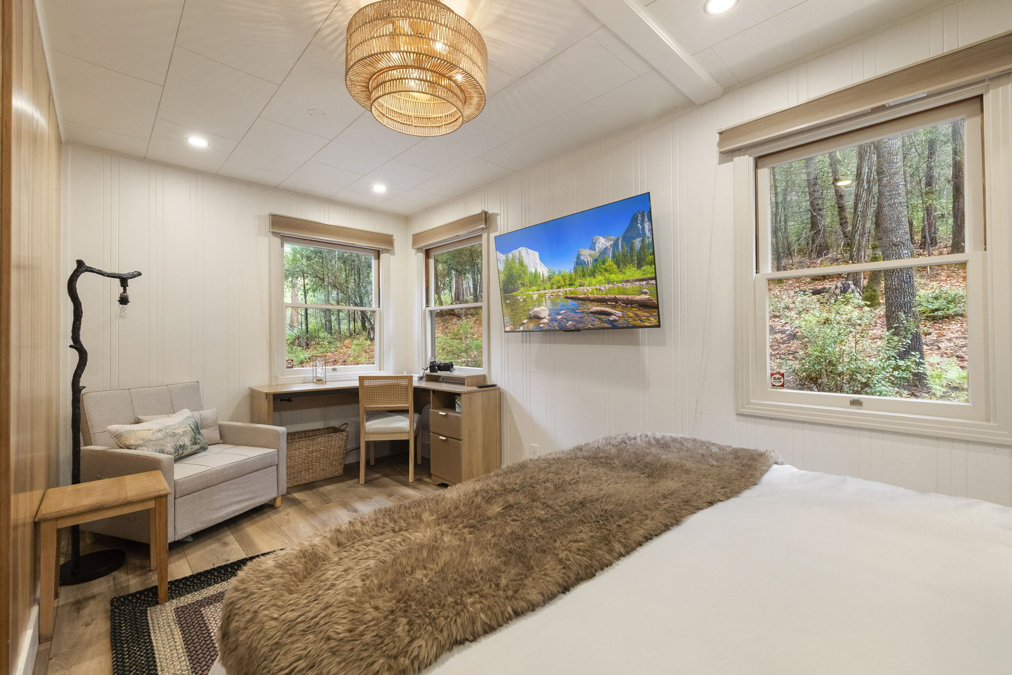 Master bedroom with a fandalier, queen memory foam mattress and separate work/relax area within the room.