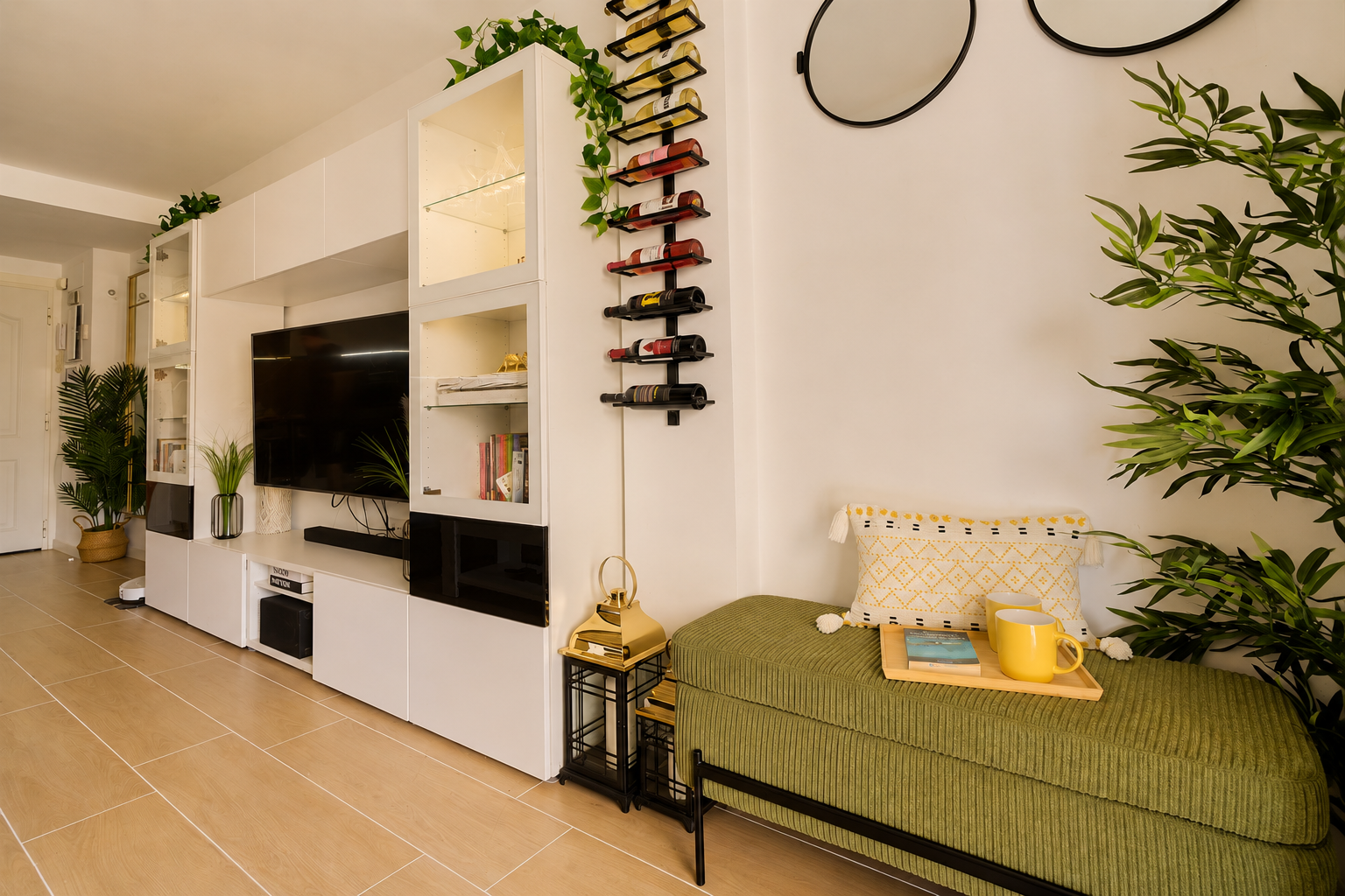 Stylish open-plan living room with a modern kitchen, smart TV, and natural light throughout — ideal for relaxing or sharing a glass of wine after a day by the beach.