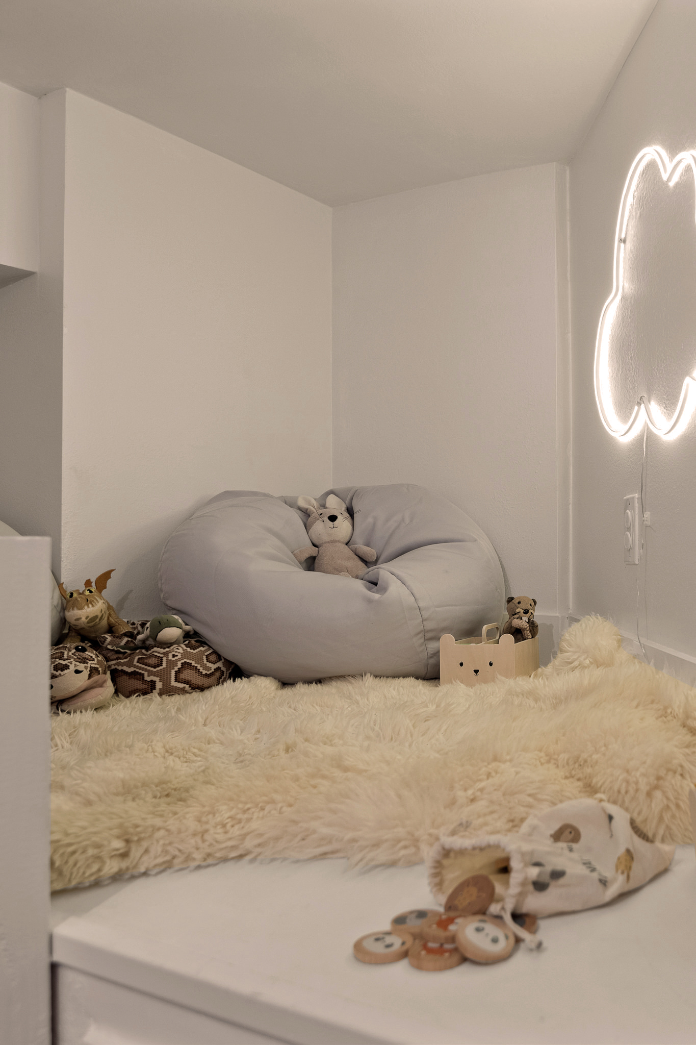 Soft, cozy kids’ corner with plush seating and warm lighting—an inviting space for playtime or quiet moments.