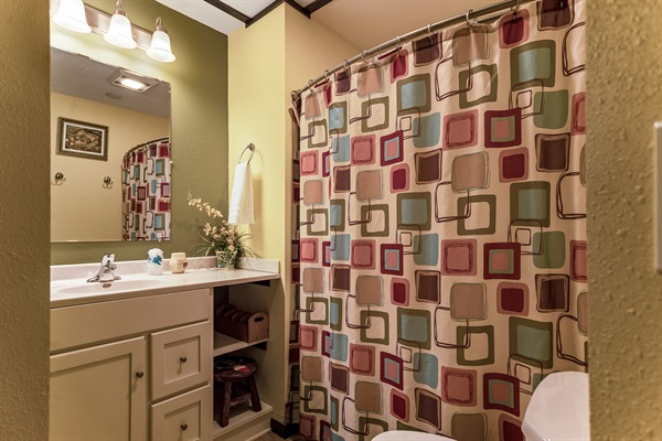 The upstairs full bathroom has a tub/shower combo and beautiful artwork.