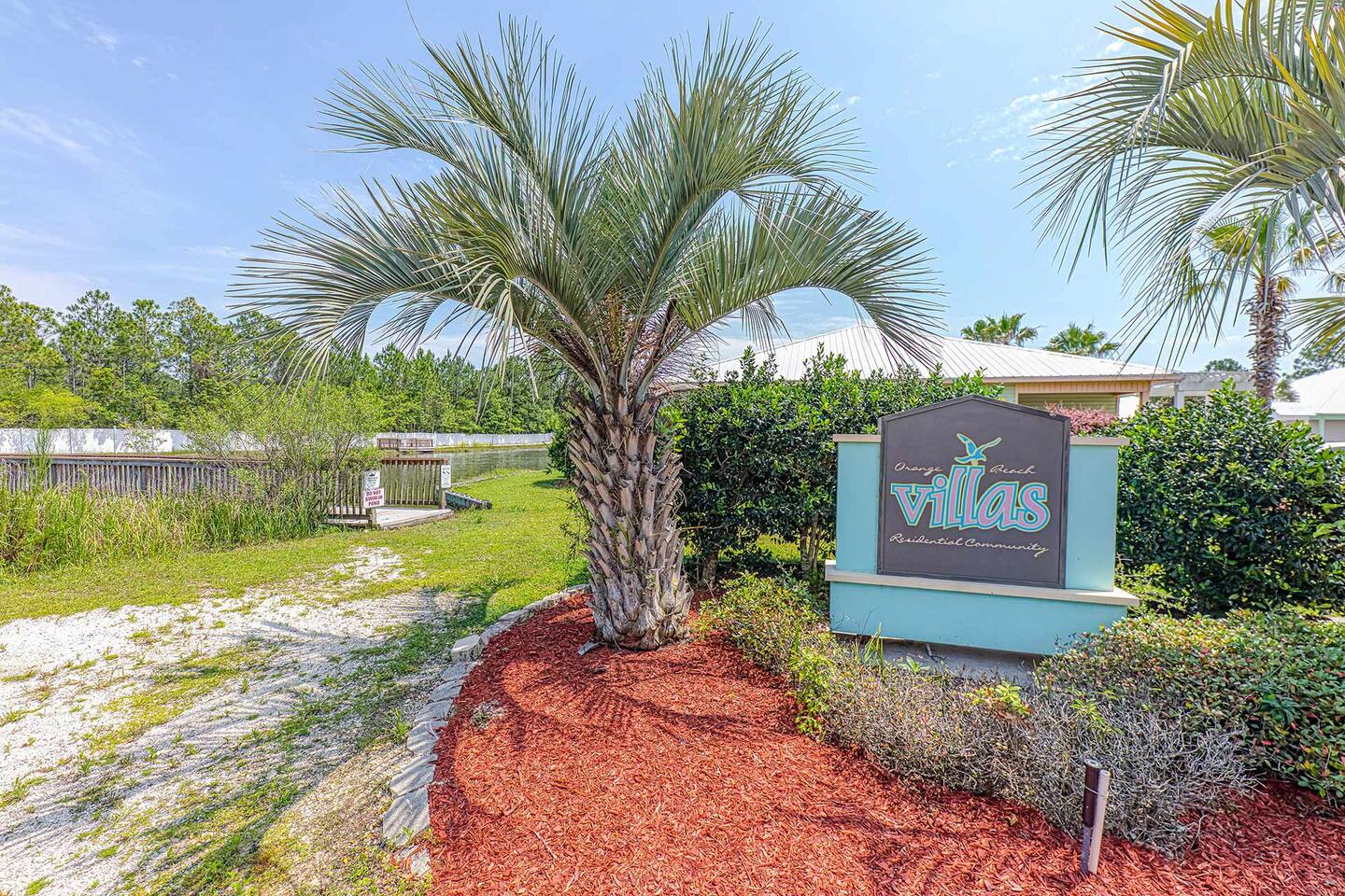 Community Entrance: Embrace coastal vibes at our welcoming villas surrounded by lush scenery!