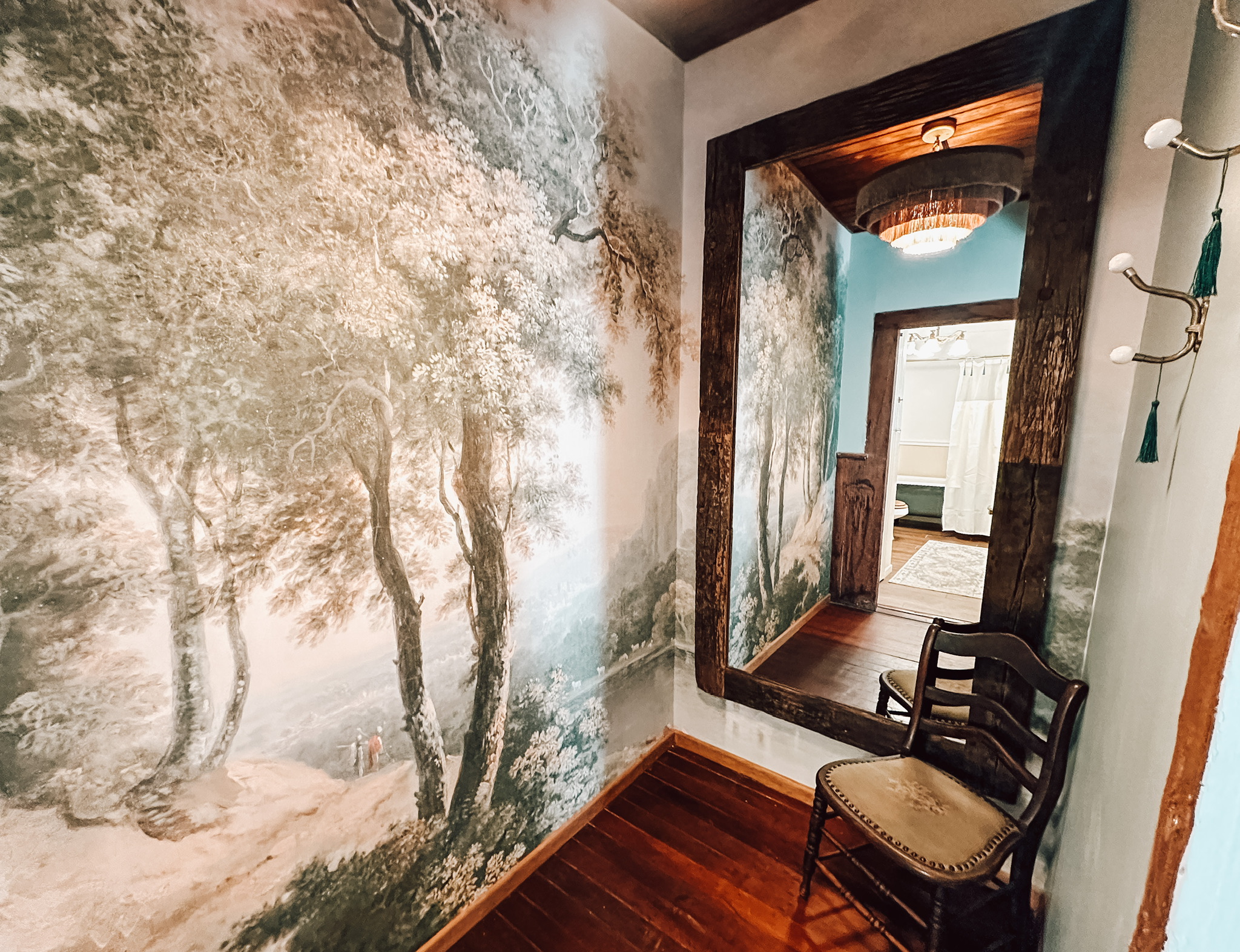 A jewel-box dressing room wrapped in a dreamy woodland mural, with a full-length mirror and direct passage from the first-floor primary to its private bath. Because even getting dressed should feel like part of the escape.
