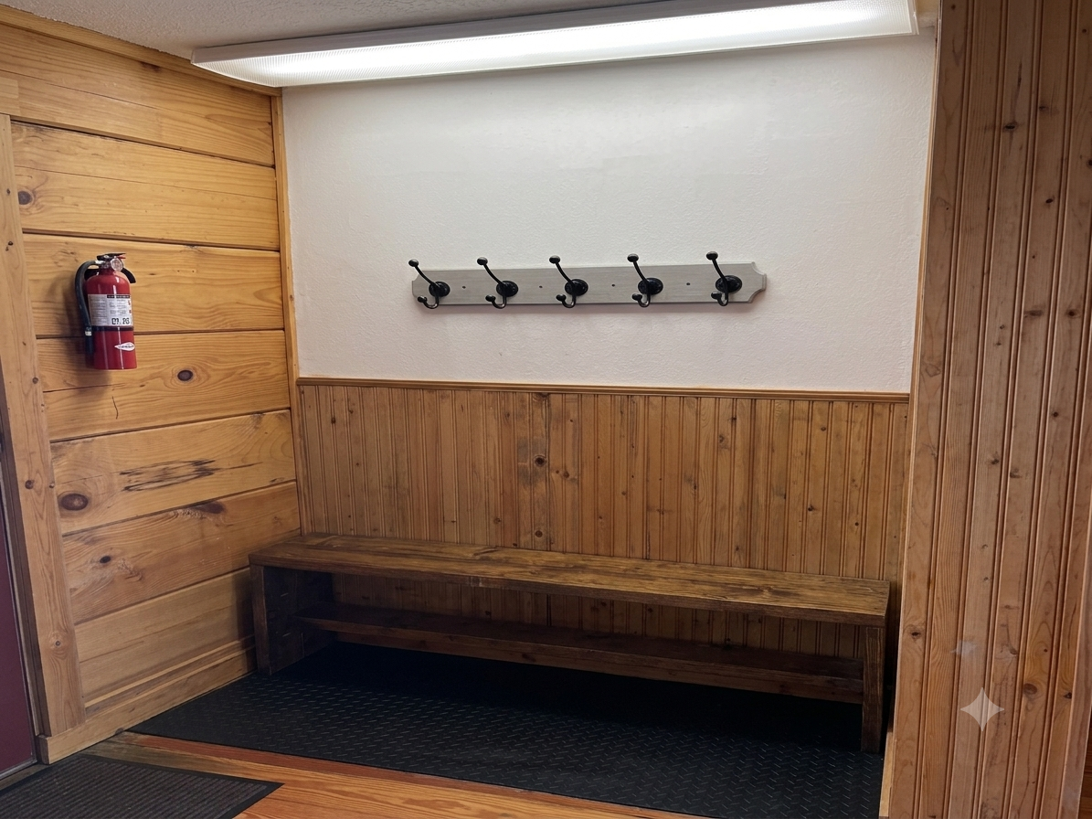 Entryway bench and wall hooks provide a convenient place to set down bags and hang coats.