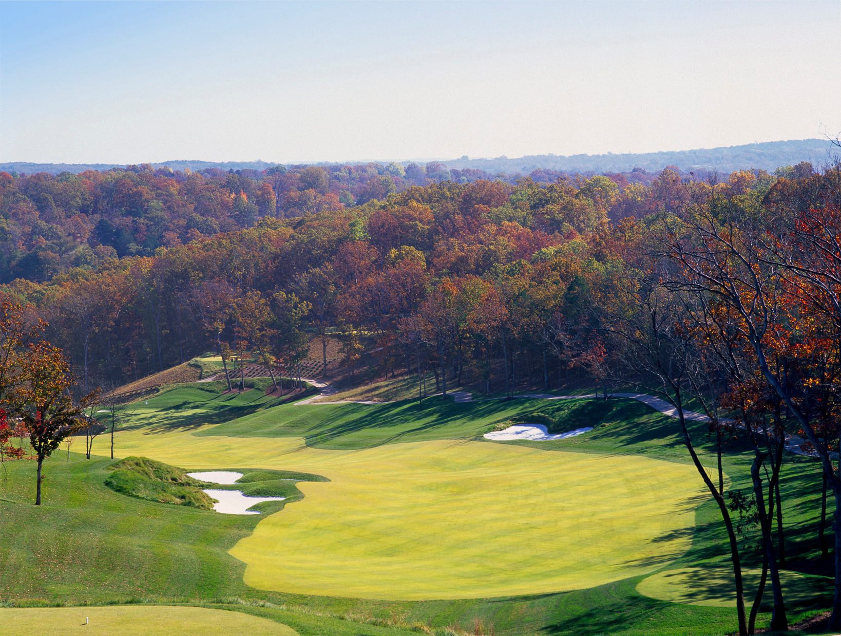 Embrace the Challenge: Navigate the scenic Ozark hills on our stunning golf course.