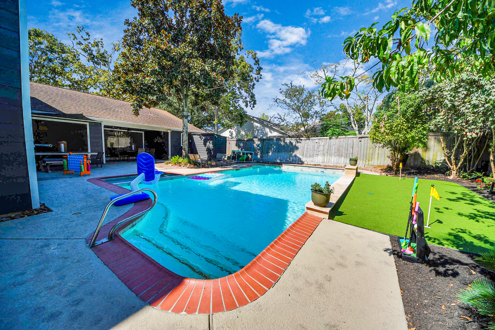 Plenty of fun to be had in this backyard with a sparkling pool, putting green, connect 4 and places to sit and soak in the sun or read a book!