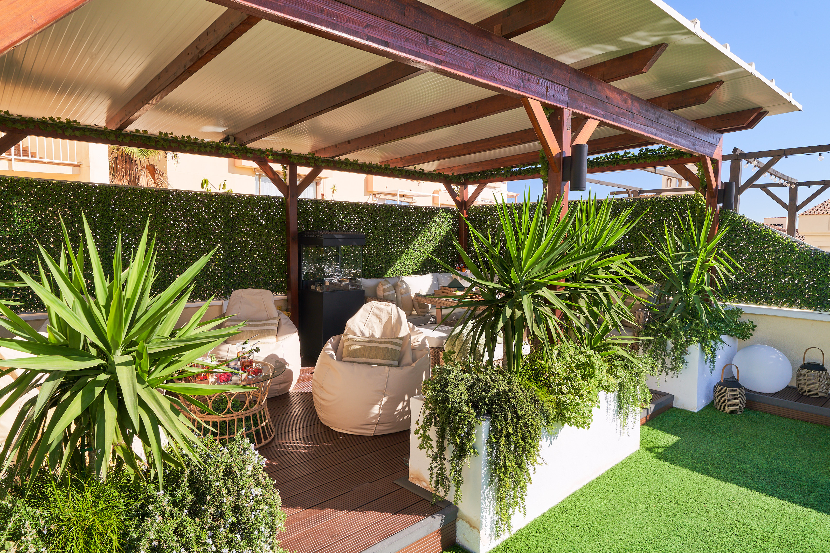 Relax beneath the covered pergola with cozy seating, fireplace, and dining area. Perfect for long evenings, romantic dinners, or movie nights on the outdoor TV under soft ambient lights.