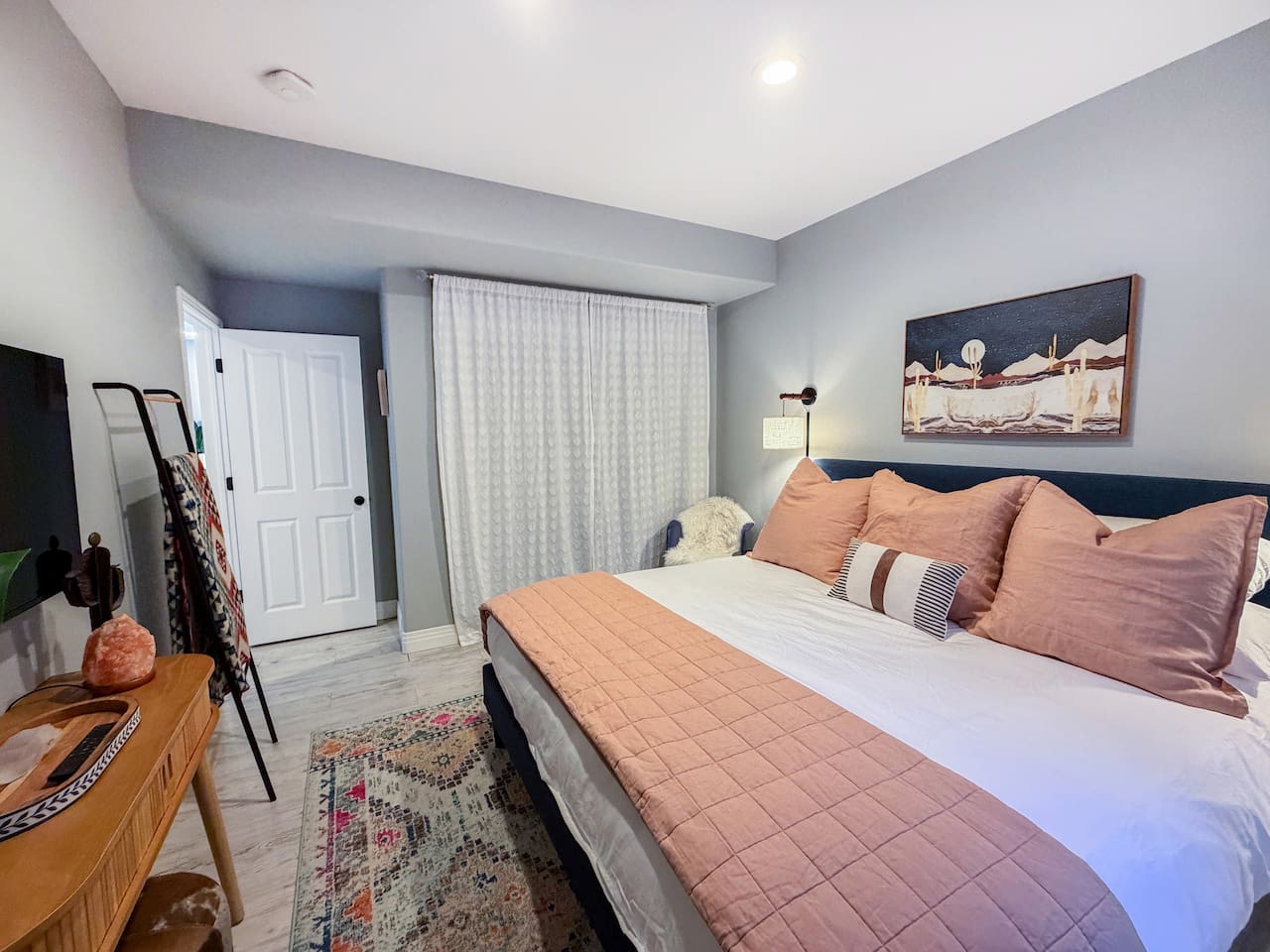 Cozy king bedroom in the entertainment area featuring soft lighting, stylish décor, and a peaceful, private retreat.