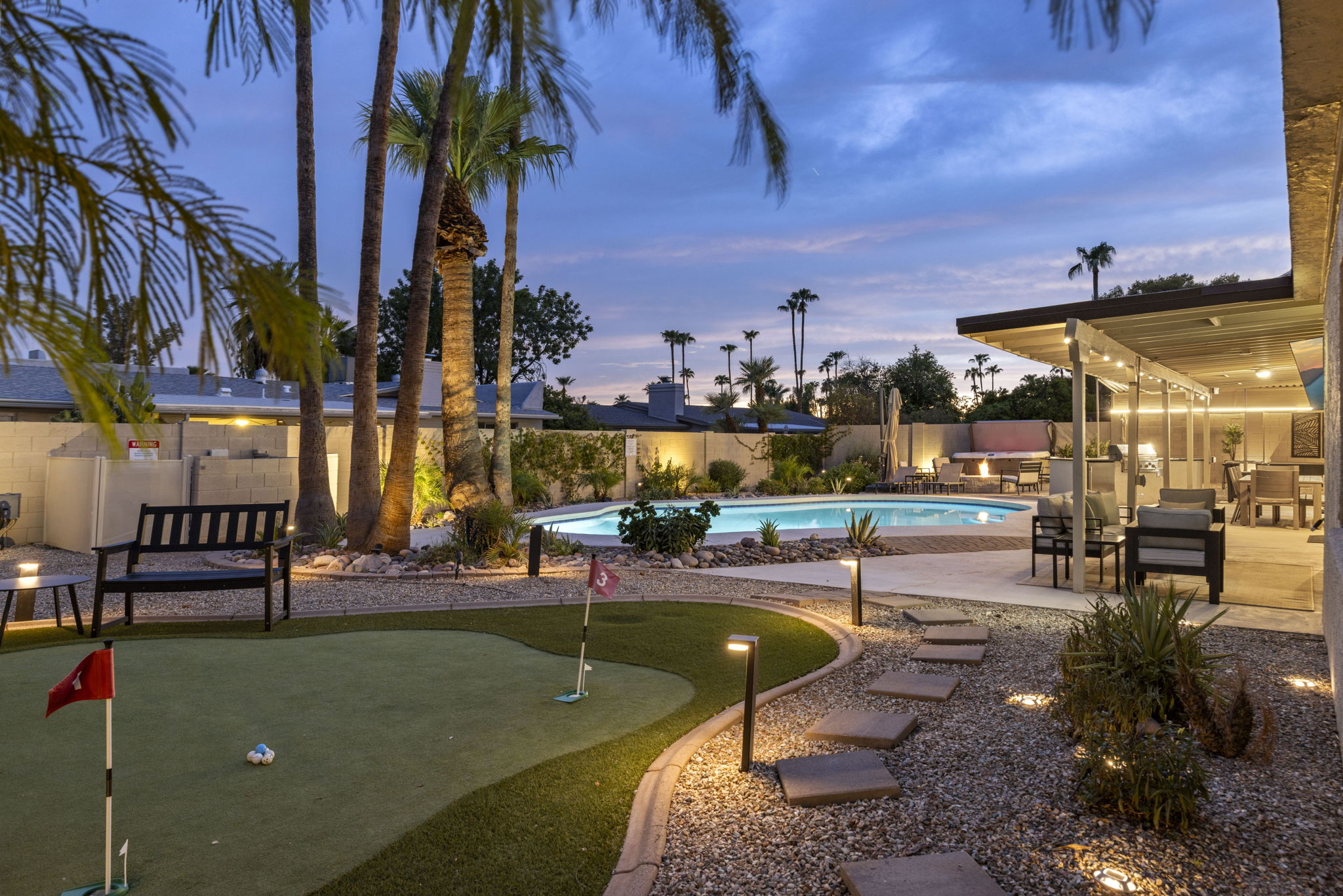 Spacious backyard with putting green and multiple areas to relax and unwind