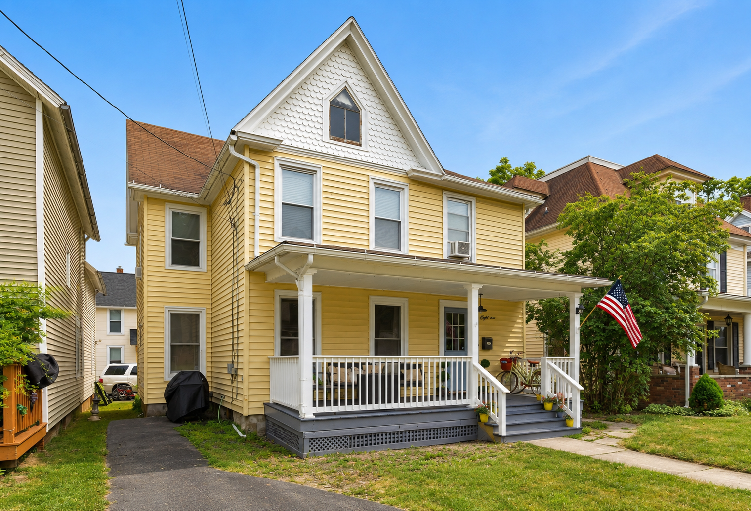 Yellow two-story home with front porch
