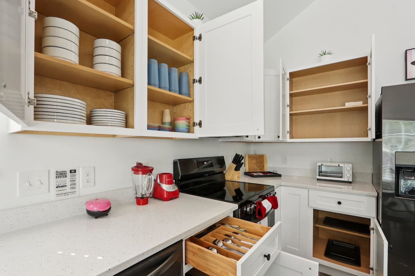 Coffee mugs with Keurig coffee maker (pods included), hot water heater, mini waffle maker, blender, stove, oven, dishwasher, fridge, filtered water, knives, cutting board, pots/pans, baking sheets, utensils.  