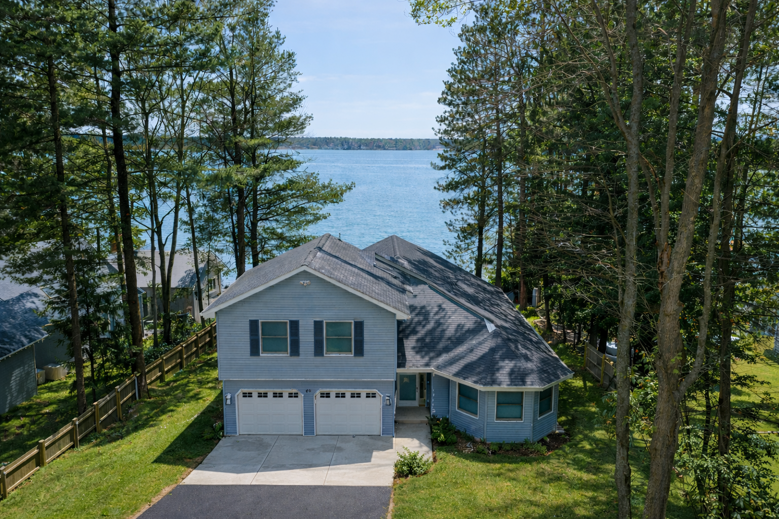 View of the lake behind the house with a blend of sun and shade to help picture a summer day on Long Lake.
