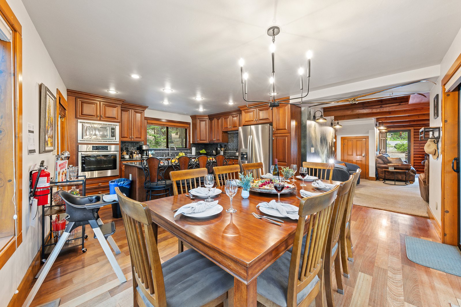 Gather every generation at one long table — high chair pulled up, fireplace glowing, the whole trip eating together.