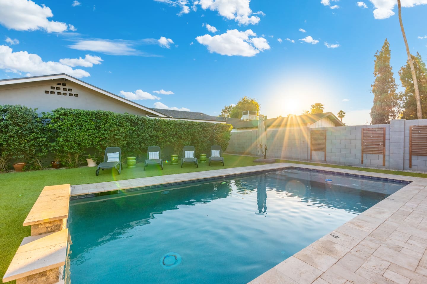 Tranquil poolside area, offering a relaxing space with comfortable seating and easy access to the refreshing pool.