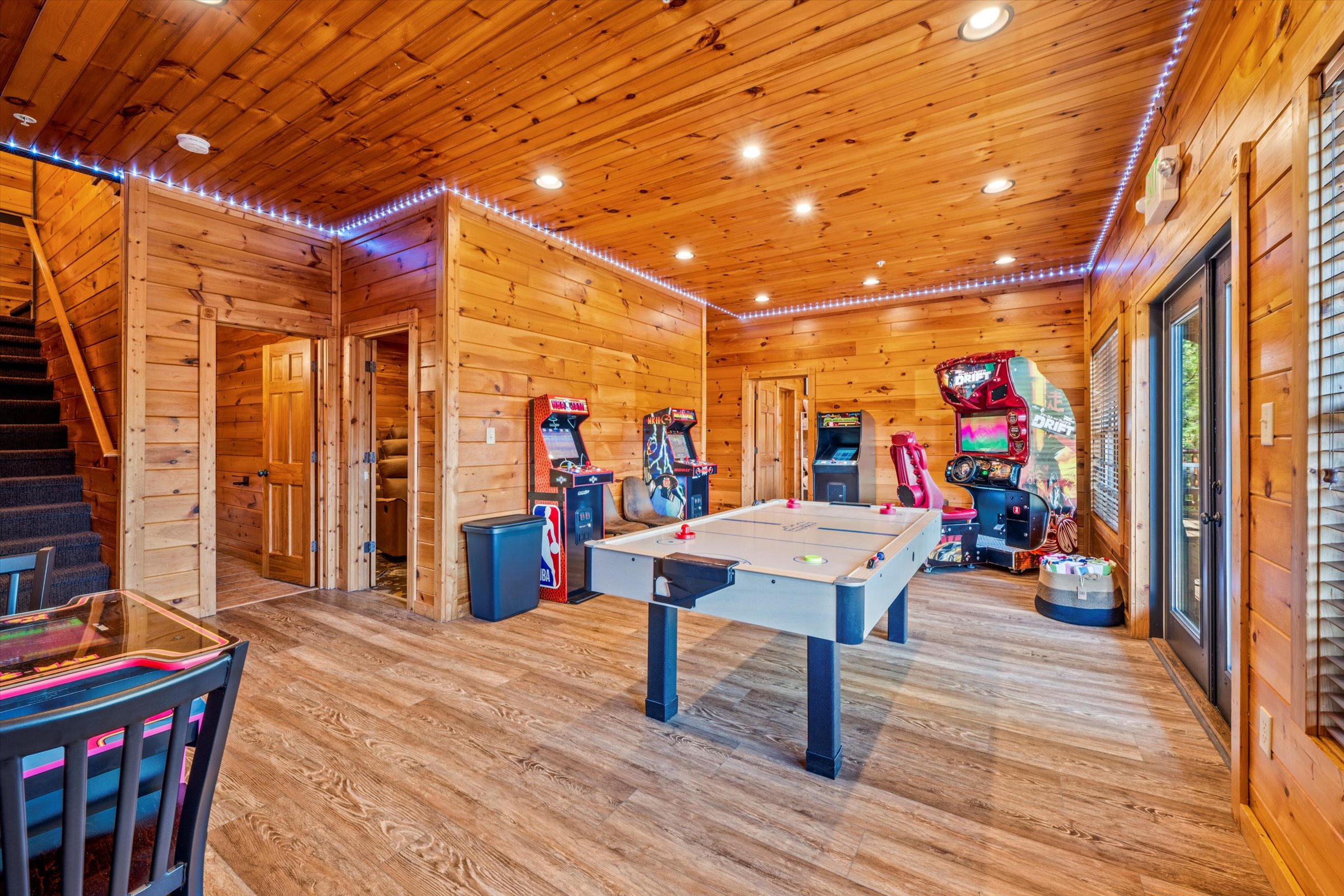 The arcade has 5 video game machines and an air hockey table