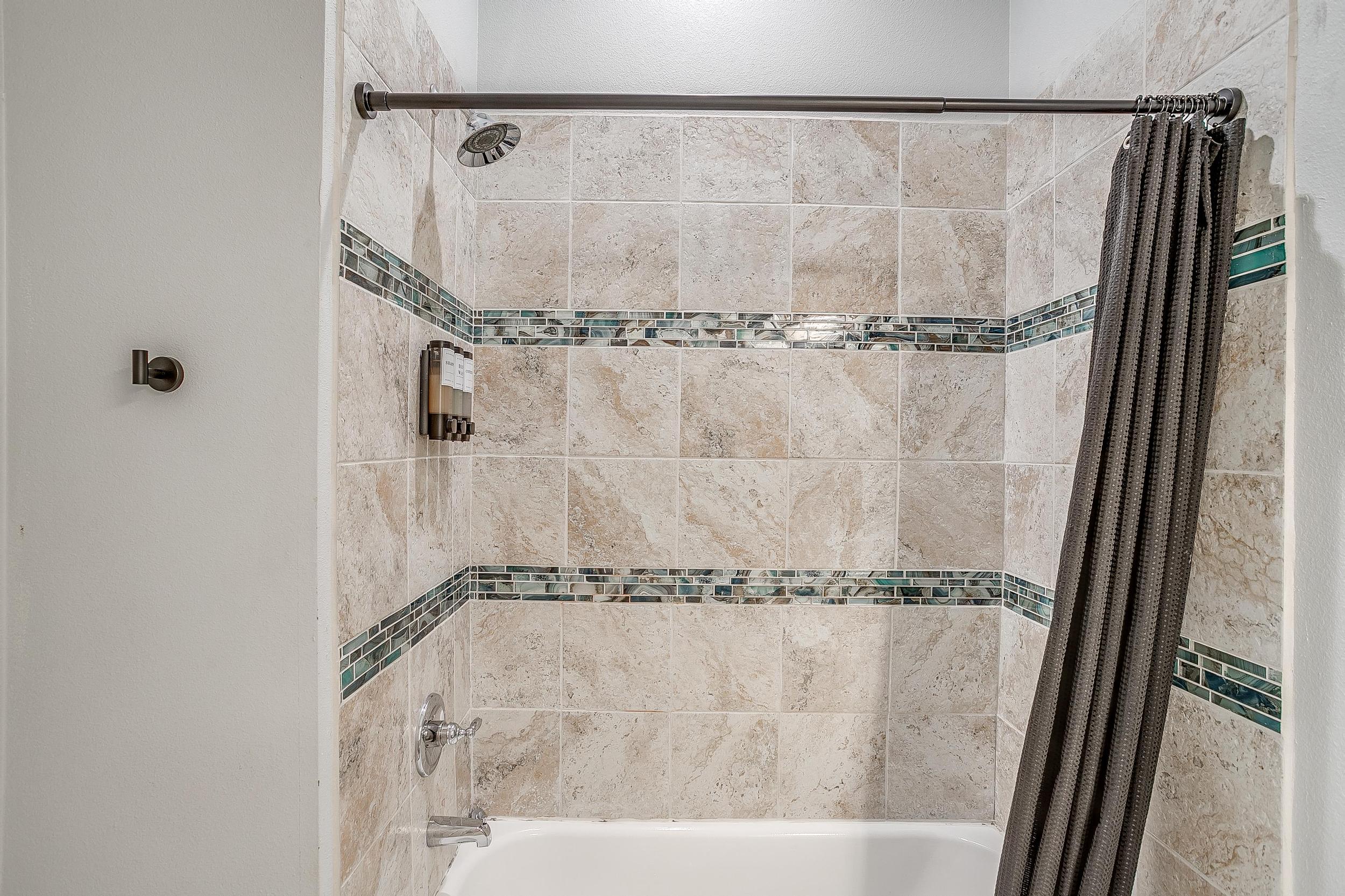 Bright walk-in shower with clean tile and fresh vibe.