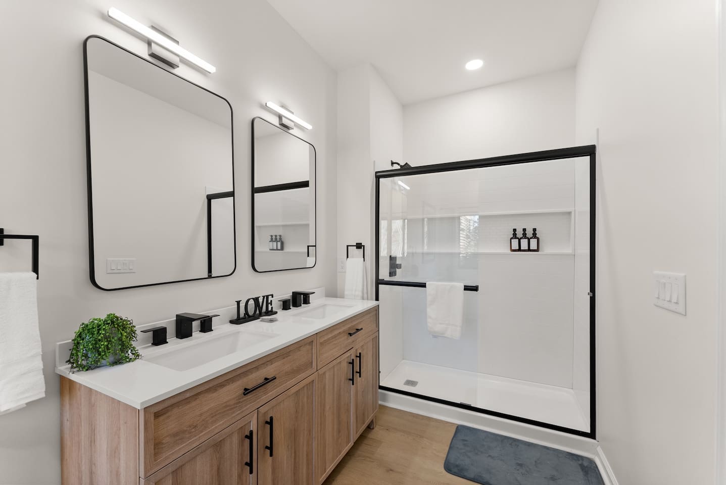 Master bathroom featuring a shower and double sinks