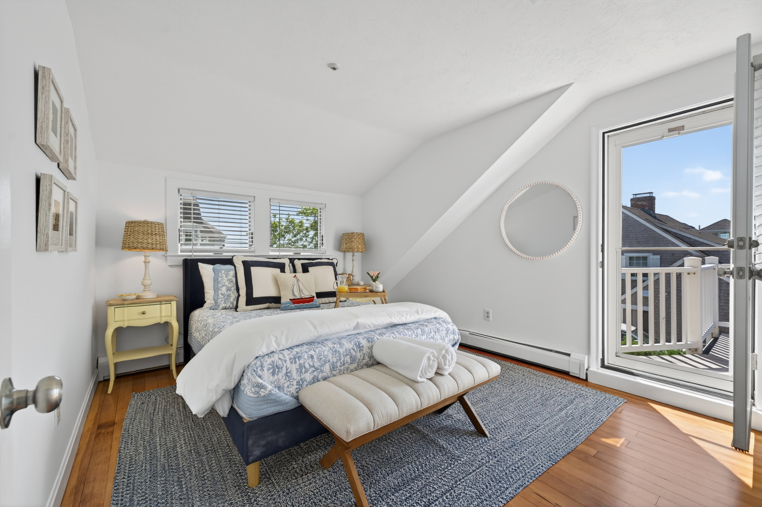 Bright queen bedroom with easy bathroom access and direct entry to the second-floor deck.