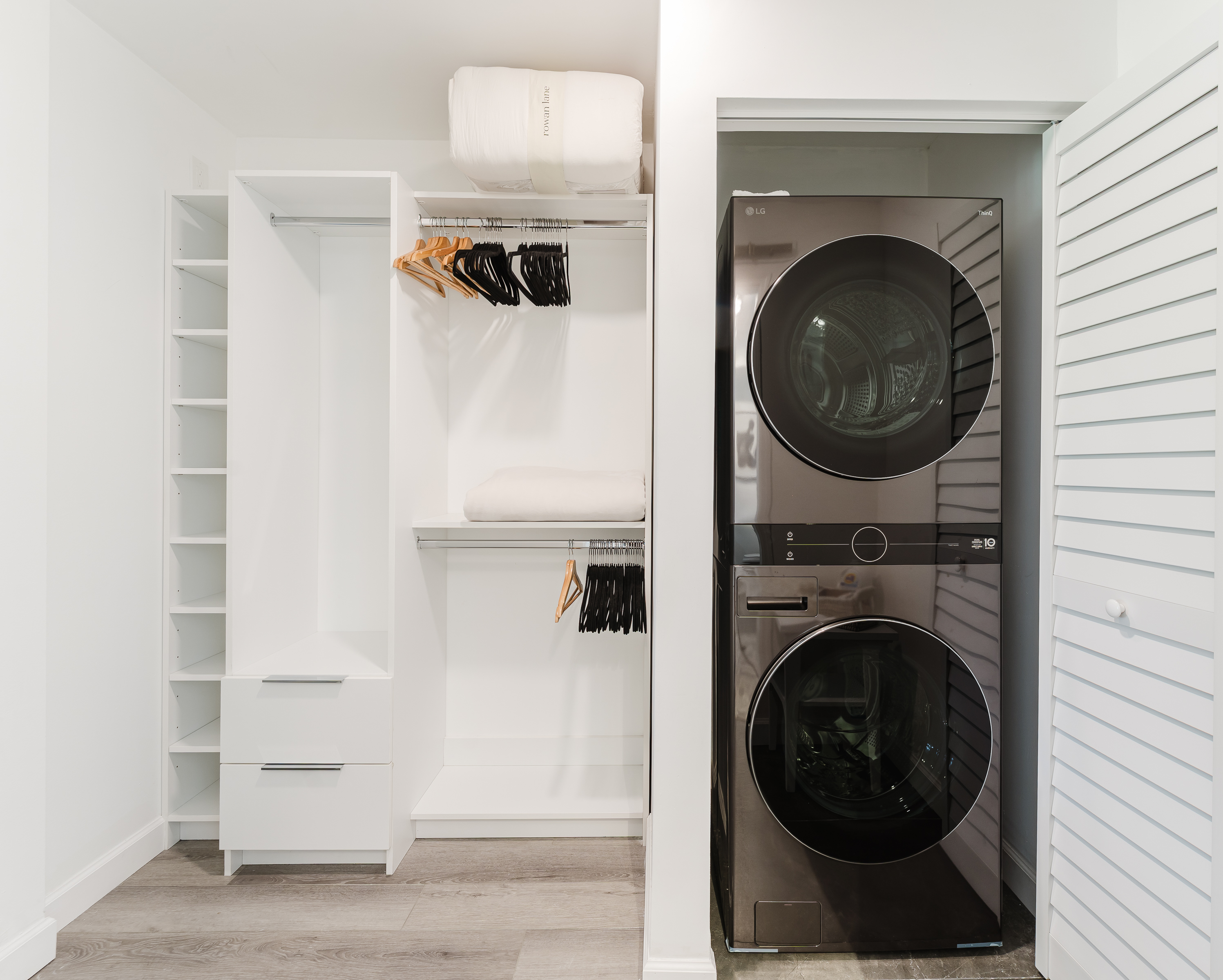 Spacious walk-in closet with built-in shelving, ample hanging space, and in-unit washer and dryer for ultimate convenience during your stay.
